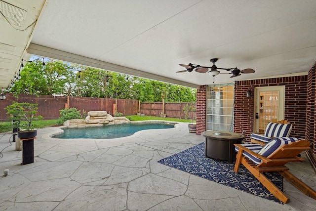 view of pool featuring a fenced backyard, a patio area, a fenced in pool, and a ceiling fan