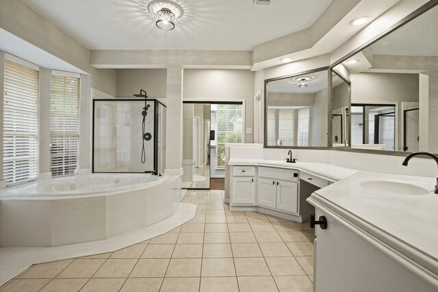 full bath with a garden tub, tile patterned floors, a sink, a stall shower, and recessed lighting