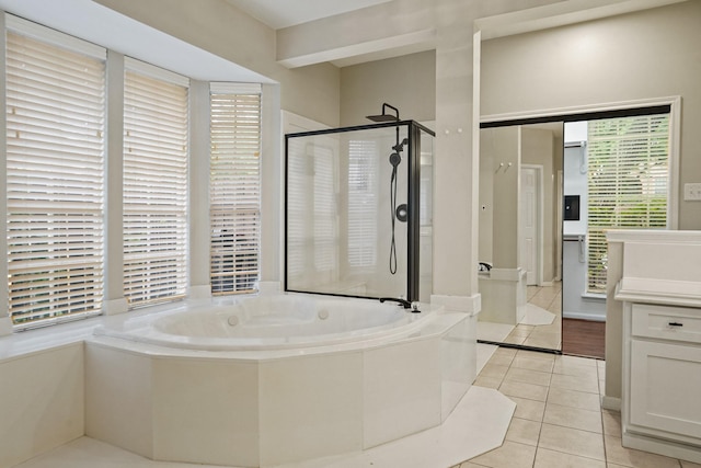 full bathroom featuring a bath, tile patterned floors, vanity, and a stall shower