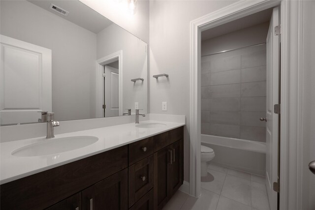 809 Coronado Terrace Ln, Katy, TX 77493 - full bath featuring toilet, double vanity, tile patterned floors, and washtub / shower combination
