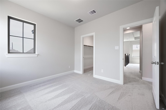 809 Coronado Terrace Ln, Katy, TX 77493 - unfurnished bedroom with carpet flooring, a walk in closet, and baseboards