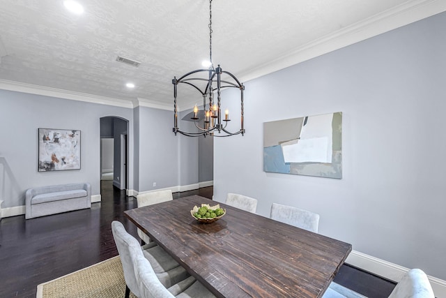 dining area featuring arched walkways, baseboards, recessed lighting, a chandelier, and crown molding