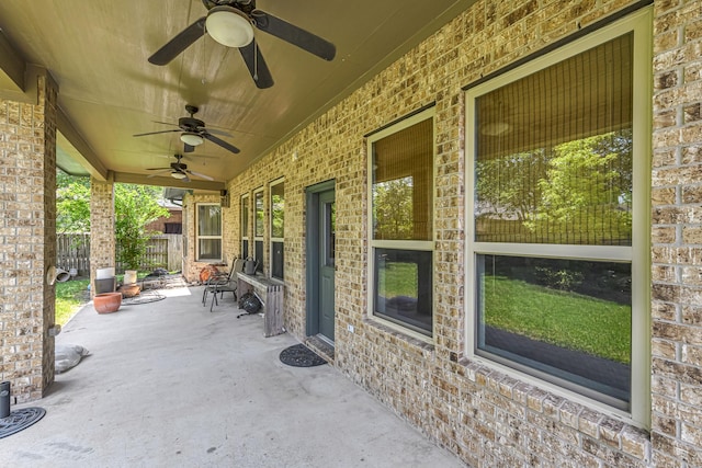 view of patio / terrace with fence and ceiling fan