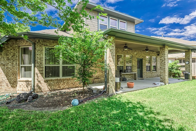 12510 Cove Landing Dr, Cypress, TX 77433 - rear view of property with ceiling fan, brick siding, a lawn, and a patio area