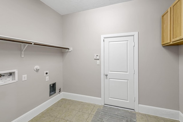 washroom featuring gas dryer hookup, baseboards, electric dryer hookup, cabinet space, and washer hookup