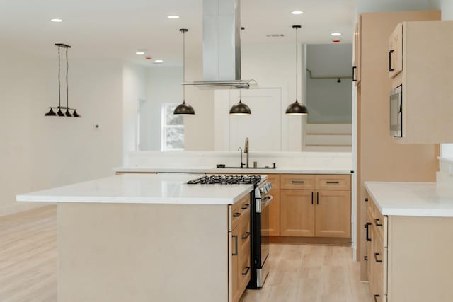 2711 Delano St, Houston, TX 77004 - kitchen featuring stainless steel gas range, a sink, extractor fan, light wood finished floors, and light countertops