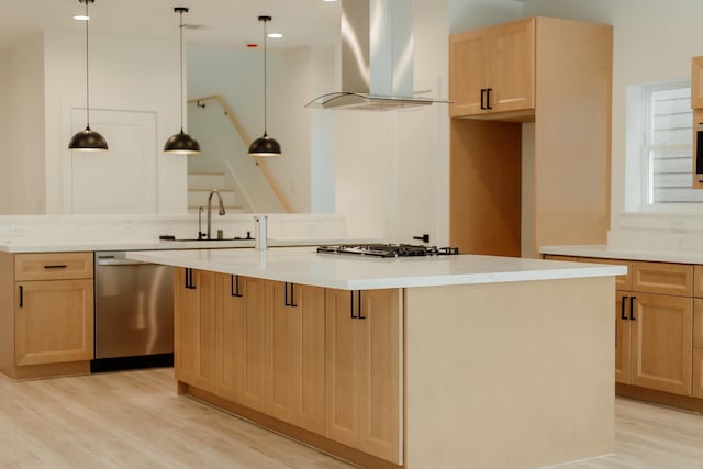2711 Delano St, Houston, TX 77004 - kitchen with appliances with stainless steel finishes, exhaust hood, light brown cabinets, a sink, and light wood finished floors