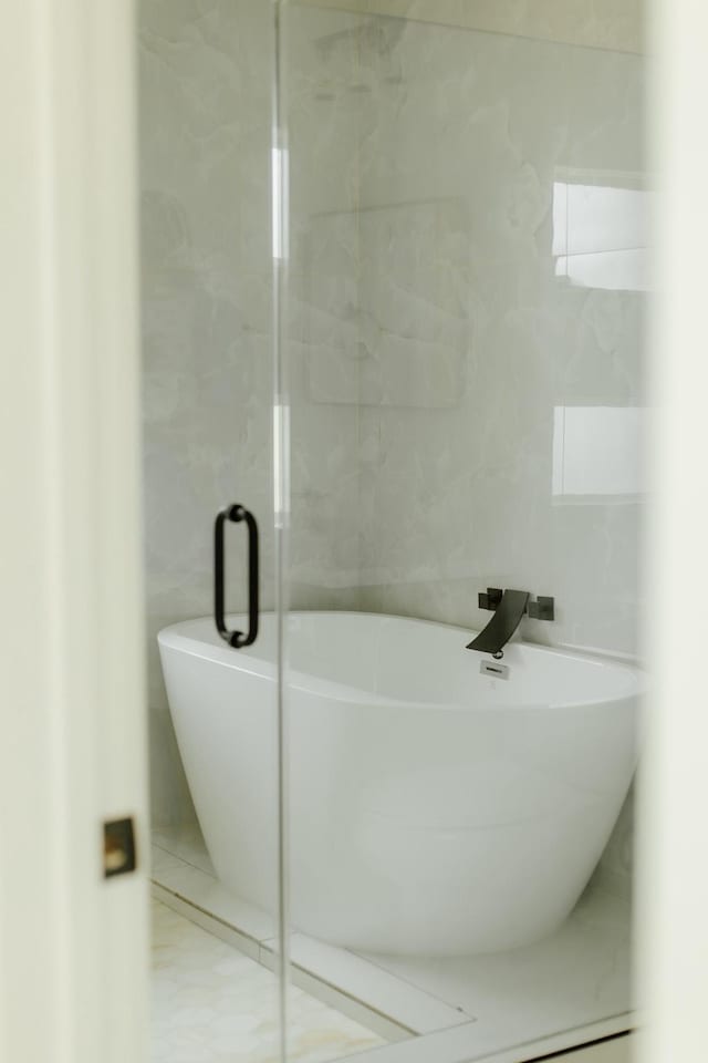 2711 Delano St, Houston, TX 77004 - bathroom with tile walls and a soaking tub
