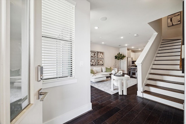 interior space with baseboards, wood finished floors, recessed lighting, and stairs