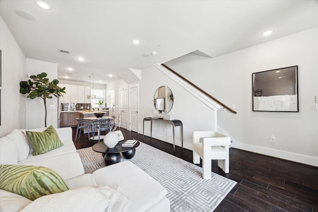 living area with stairway, visible vents, baseboards, dark wood-style floors, and recessed lighting