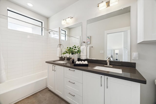 full bathroom with double vanity, shower / bathtub combination, tile patterned floors, and a sink