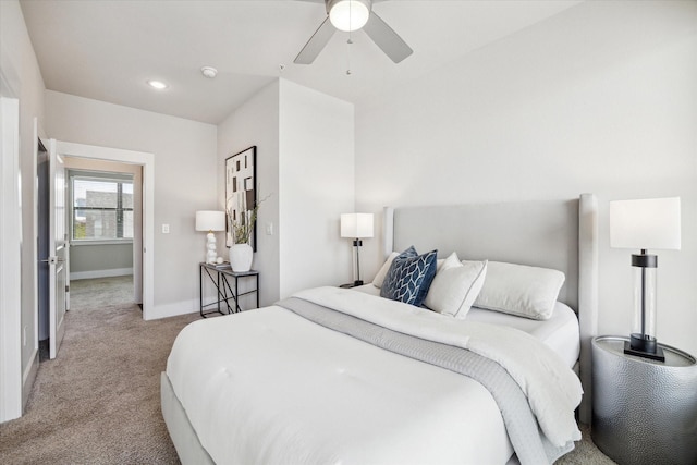 carpeted bedroom with a ceiling fan and baseboards