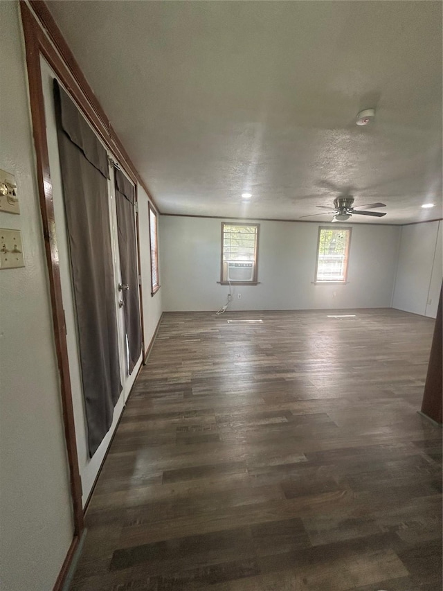 spare room featuring cooling unit, wood finished floors, and ceiling fan