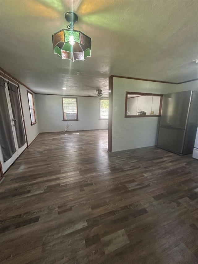 interior space with cooling unit, a ceiling fan, and dark wood-style floors