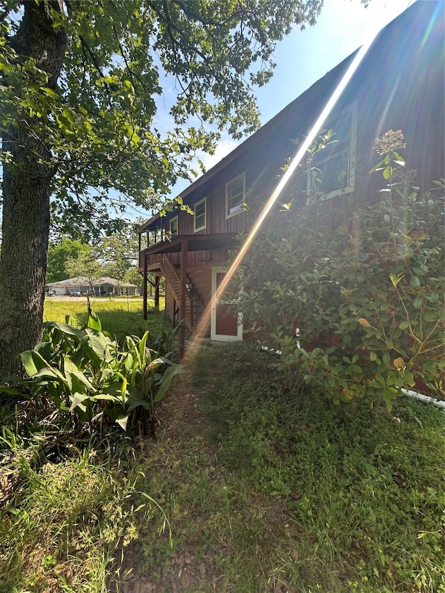 view of yard featuring stairway and a deck