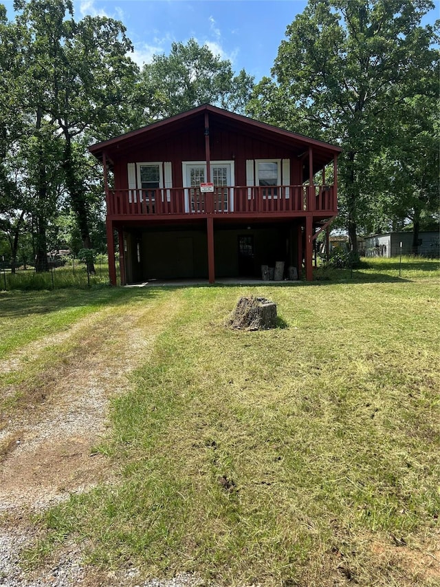 back of property featuring a lawn and a wooden deck