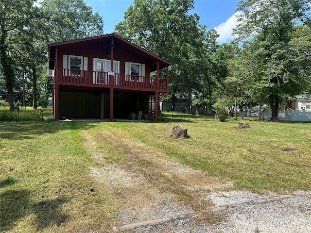 exterior space with fence, a front yard, and a deck