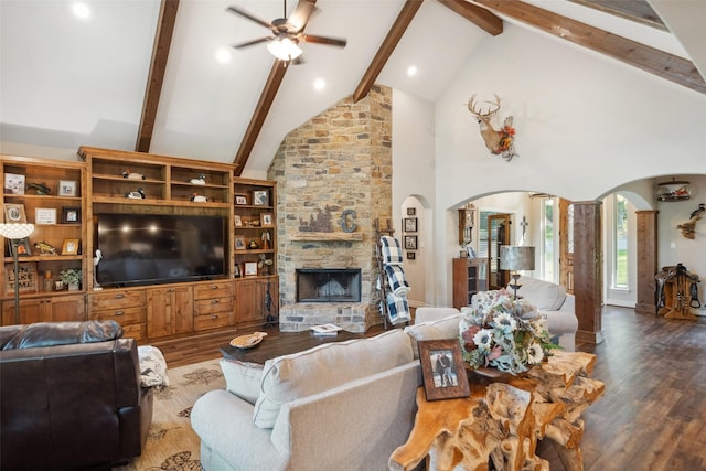 living room featuring high vaulted ceiling, a ceiling fan, wood finished floors, arched walkways, and beam ceiling