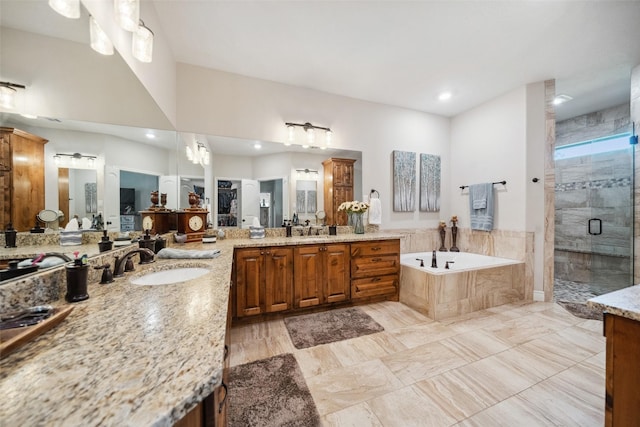bathroom with recessed lighting, a shower stall, a garden tub, and vanity