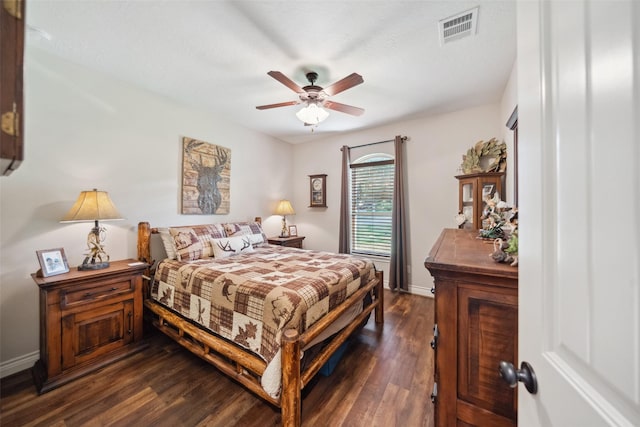 bedroom with visible vents, a ceiling fan, baseboards, and dark wood-style flooring