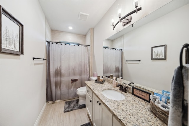 bathroom featuring wood finished floors, toilet, vanity, baseboards, and a shower with shower curtain