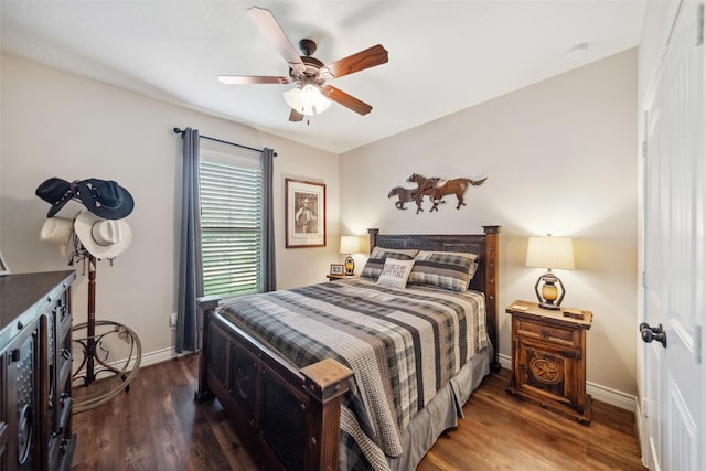 bedroom featuring wood finished floors, baseboards, and ceiling fan