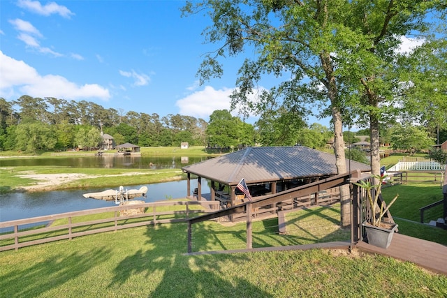 dock area with a lawn and a water view