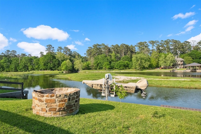 dock area featuring a lawn and a water view