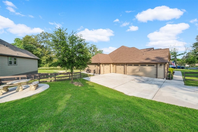 exterior space with a gate, fence, a front lawn, concrete driveway, and an attached garage