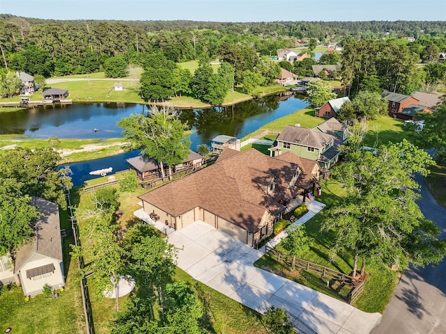 birds eye view of property featuring a residential view, a wooded view, and a water view