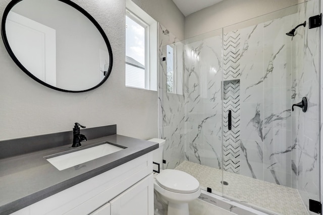 full bathroom with toilet, vanity, and a marble finish shower