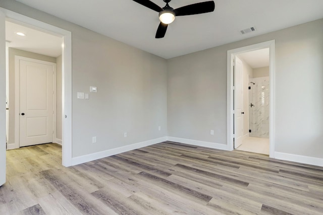 empty room featuring baseboards, a ceiling fan, wood finished floors, and visible vents