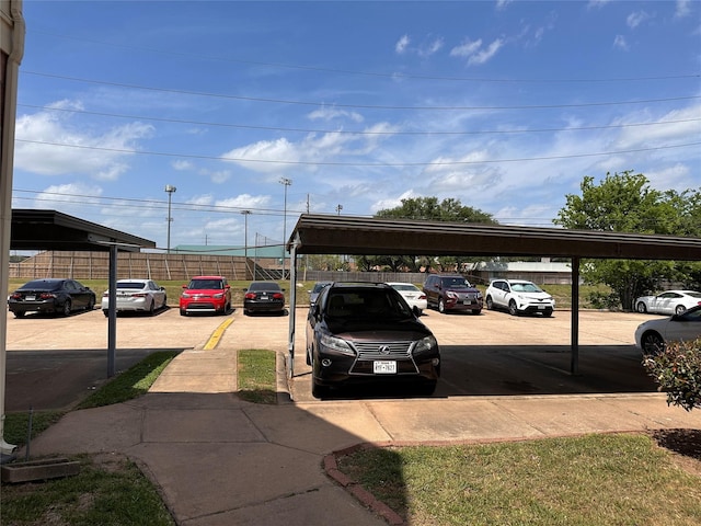 uncovered parking lot featuring fence