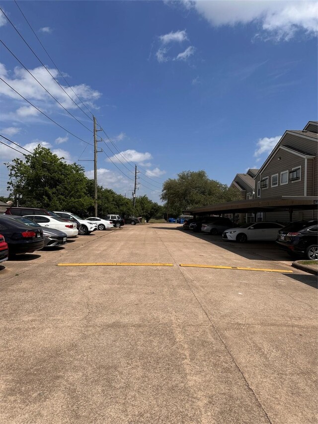 view of partially covered parking lot