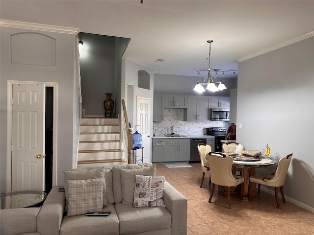 dining area featuring baseboards, visible vents, a notable chandelier, stairs, and crown molding