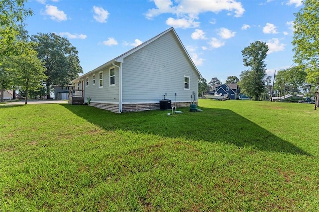view of home's exterior with a yard and central AC