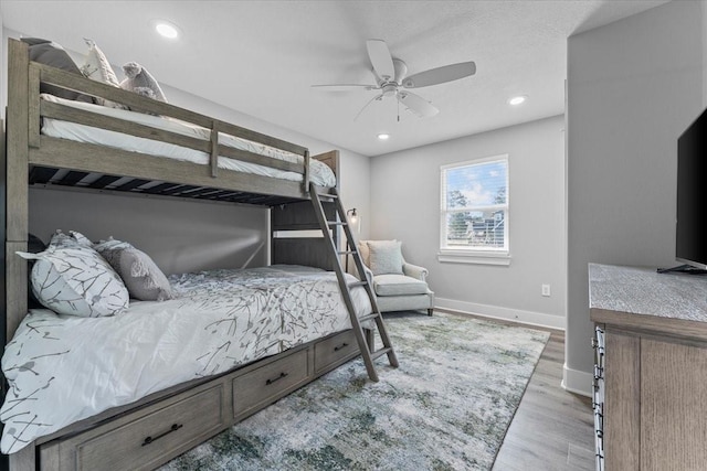 bedroom with baseboards, a ceiling fan, wood finished floors, and recessed lighting