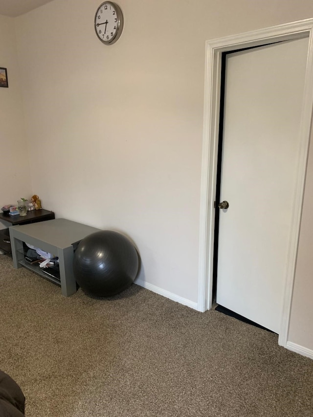 interior space featuring carpet floors and baseboards