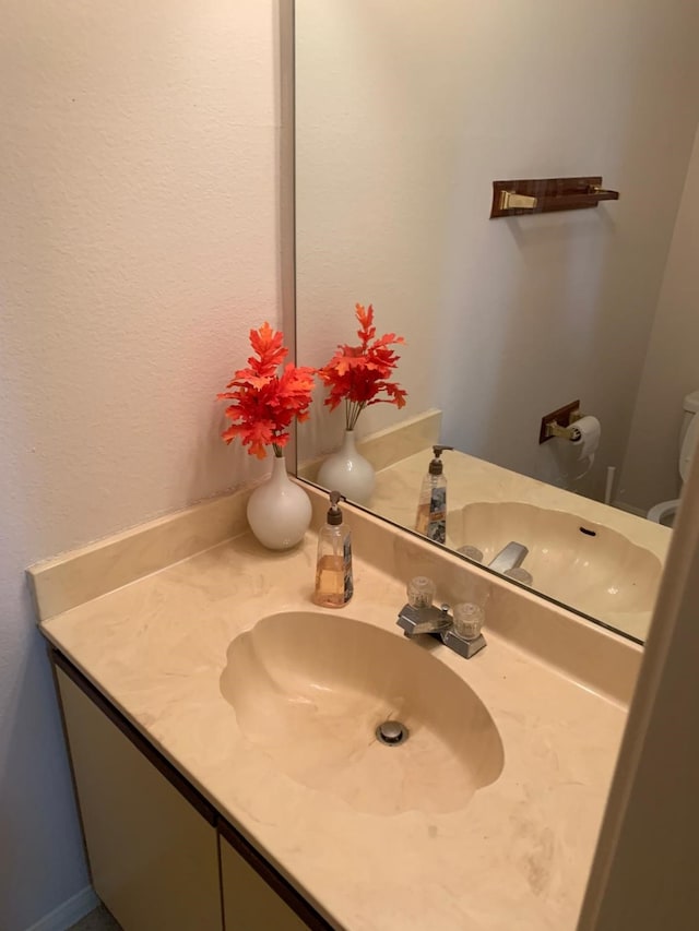 half bathroom featuring vanity