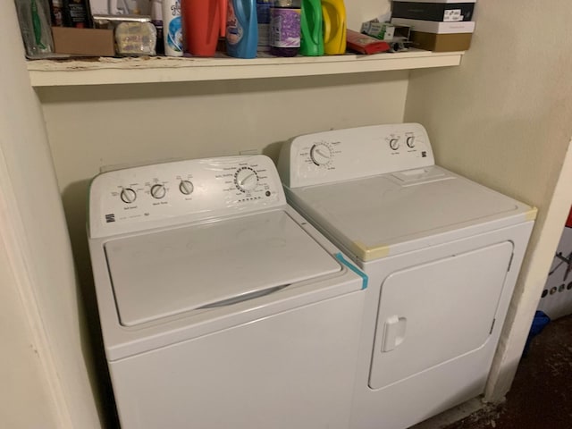washroom featuring laundry area and separate washer and dryer