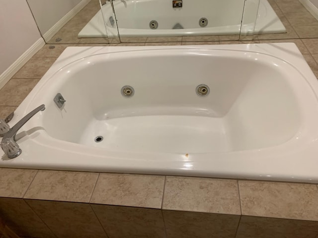 bathroom featuring a whirlpool tub, tile patterned floors, and baseboards