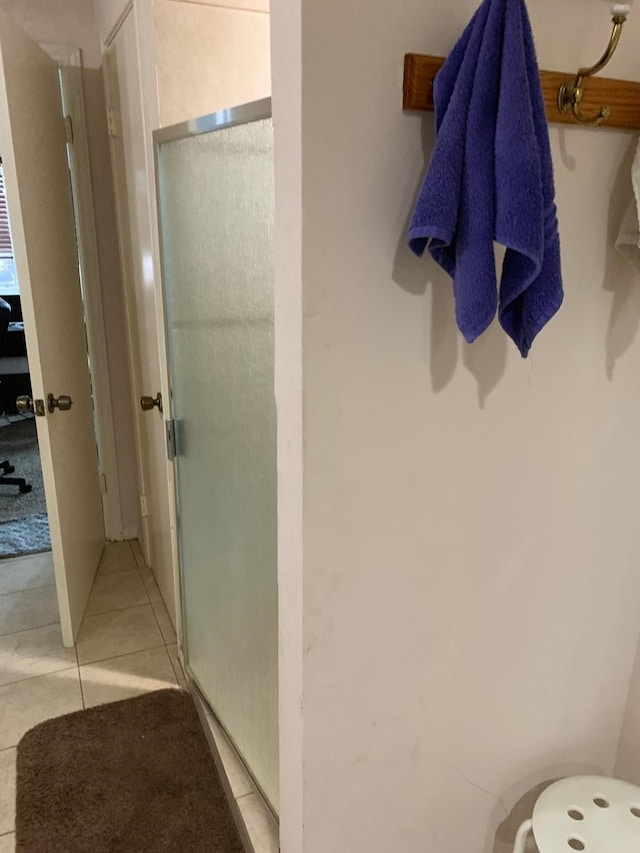 full bath with tile patterned flooring and a stall shower