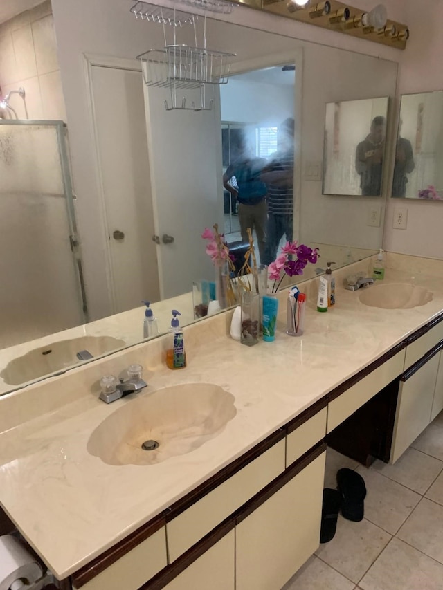full bath with tile patterned floors, a sink, and double vanity