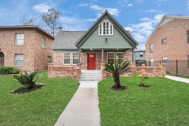 3013 Prospect St, Houston, TX 77004 - view of front of home with covered porch, fence, a front yard, brick siding, and roof with shingles