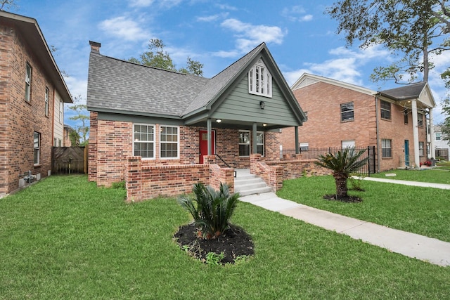 3013 Prospect St, Houston, TX 77004 - view of front of house featuring fence, covered porch, brick siding, and a front yard