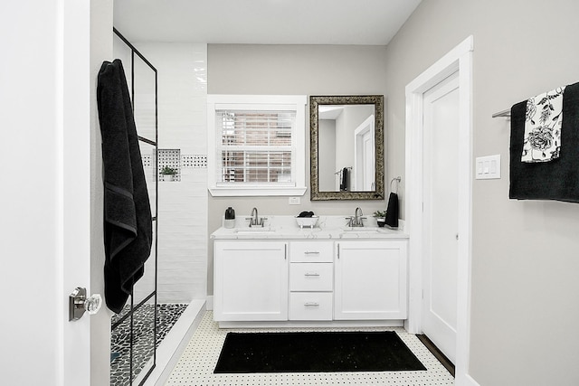 3013 Prospect St, Houston, TX 77004 - bathroom featuring double vanity, tiled shower, and a sink