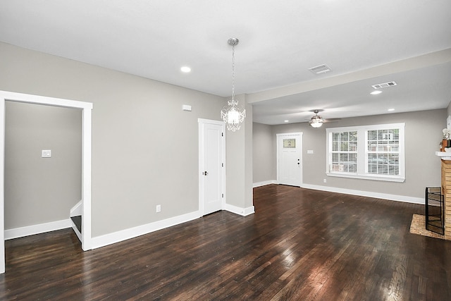 3013 Prospect St, Houston, TX 77004 - unfurnished living room featuring ceiling fan with notable chandelier, baseboards, wood finished floors, and visible vents