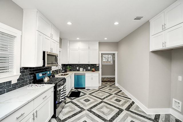 3013 Prospect St, Houston, TX 77004 - kitchen with dishwasher, stainless steel microwave, baseboards, gas stove, and visible vents