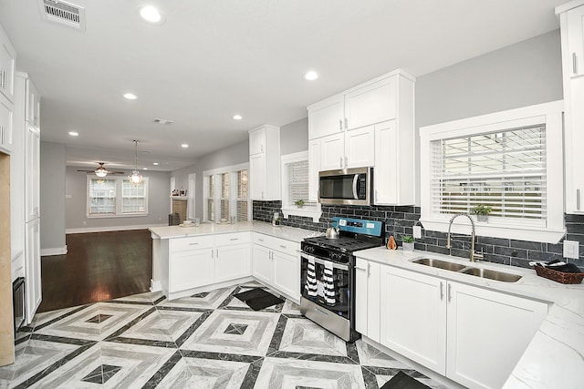 3013 Prospect St, Houston, TX 77004 - kitchen with decorative backsplash, stainless steel appliances, a sink, and recessed lighting