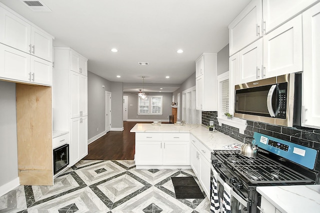 3013 Prospect St, Houston, TX 77004 - kitchen with white cabinets, recessed lighting, visible vents, a ceiling fan, and appliances with stainless steel finishes